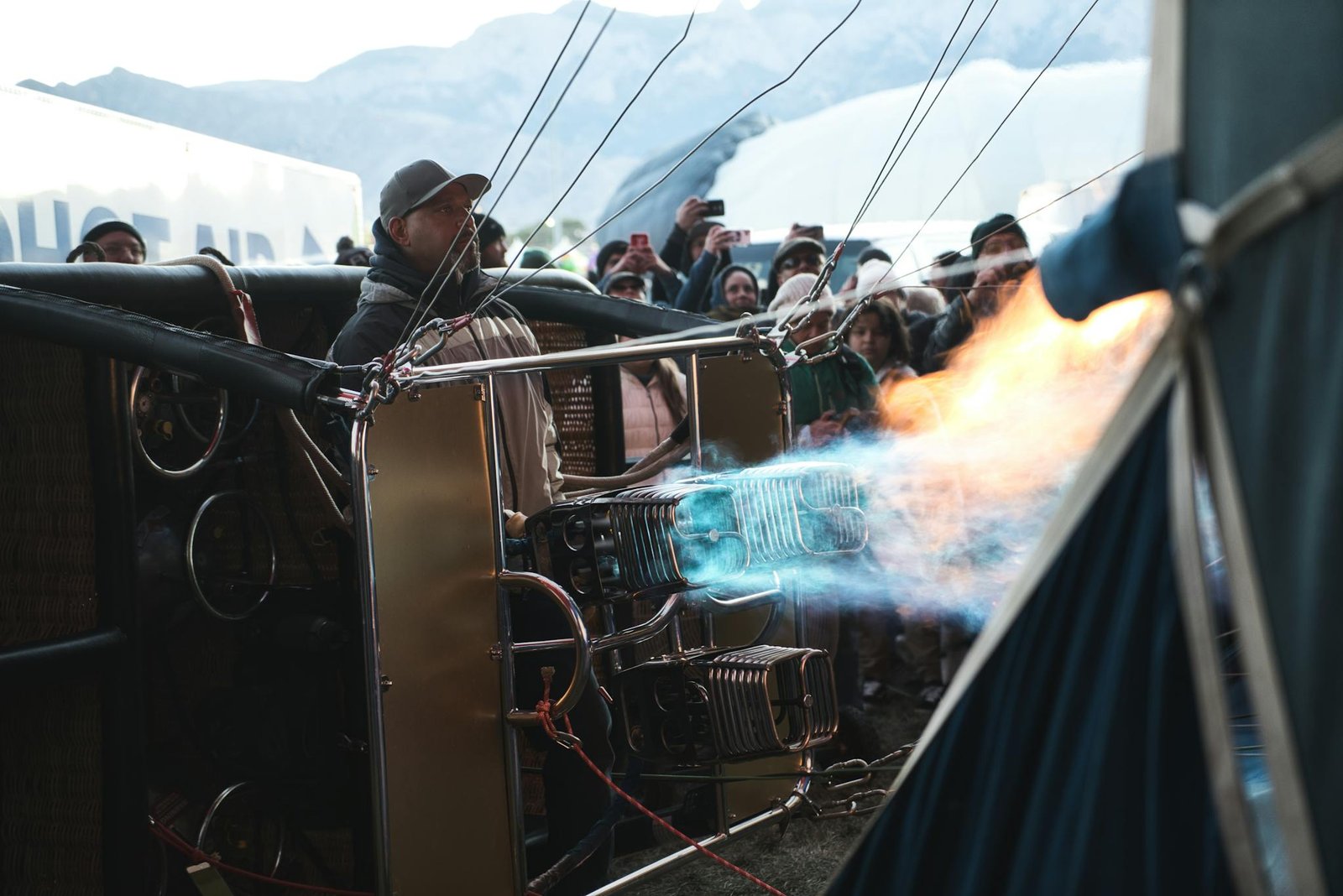 Capturing the thrill of a hot air balloon launch during the Albuquerque Balloon Fiesta with a fiery burner display.